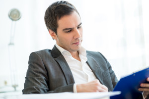 Successful  young businessman reading a report